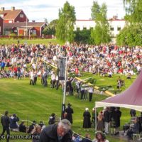 raising the maypole at midsommar festival in june in sweden