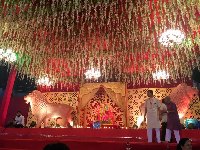 an altar decorated with 2 lions with lots of lights above