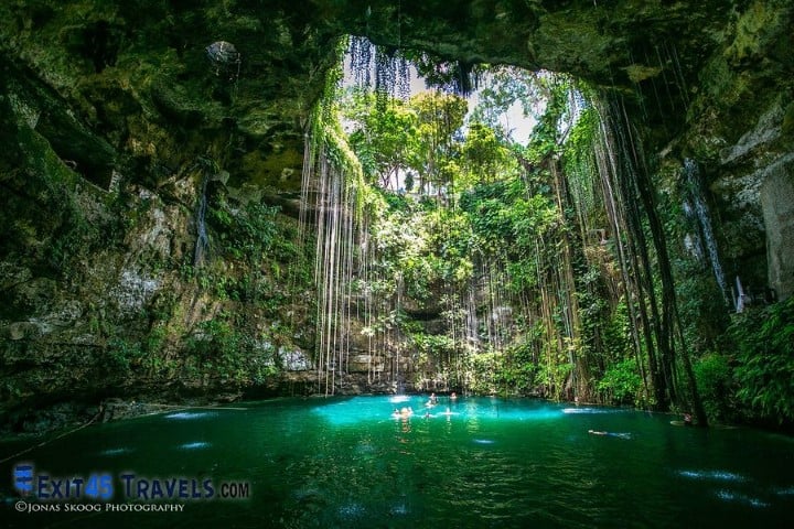 cenote in mexico with light shining through to the water. mexico is worth visiting just to see the cenotes